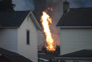 A fire burns at the site of a freight train derailment, Wednesday, Aug. 2, 2017, in Hyndman, Pa. A freight train carrying hazardous materials partly derailed early Wednesday, setting train cars and a garage on fire and prompting emergency officials to evacuate nearby residents. (Steve Bittner/The Cumberland Times-News via AP)